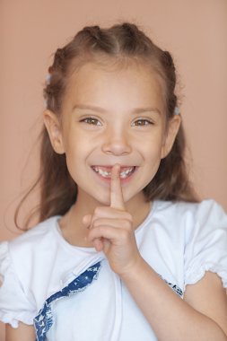 Girl-preschooler put finger to his lips clipart