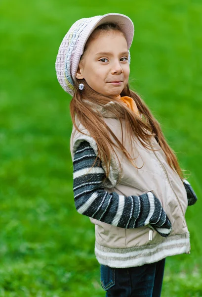 Happy girl-preschooler on green grass — Stock Photo, Image