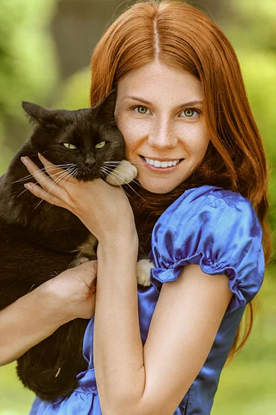 Молода жінка з чорним котом — стокове фото