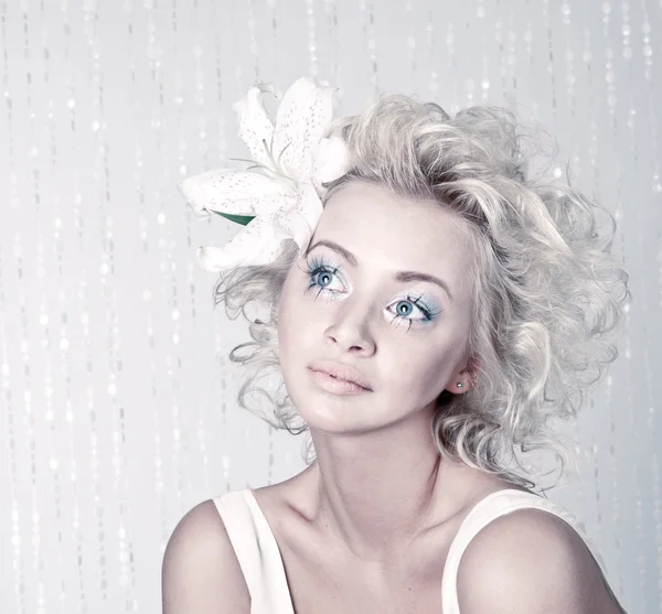 Beautiful young female with original make up and flower — Stock Photo, Image