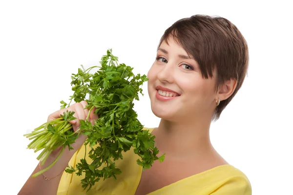 Young beautiful girl holding bunch of parsley — Stock Photo, Image