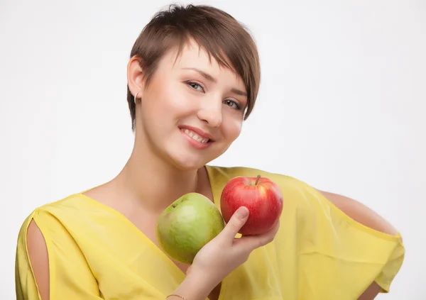 Girl holding a red and green apple. — Stock Photo, Image