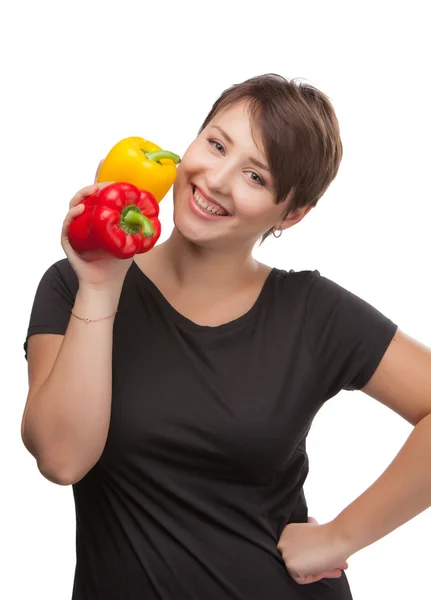 Photos of a beautiful girl with yellow and red pepper — Stock Photo, Image
