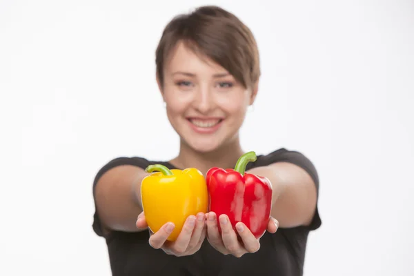 Photos of a beautiful girl with yellow and red pepper — Stock Photo, Image