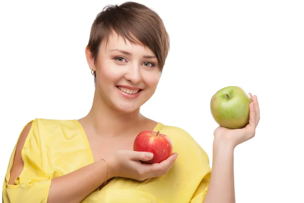 Girl holding a red and green apple. Stock Image