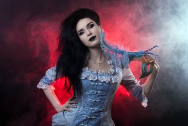 Beautiful Halloween vampire woman aristocrat over black-red background clipart