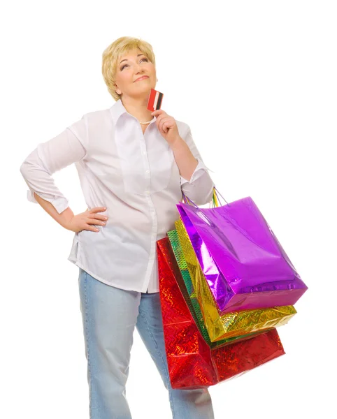 Senior mulher com cartão de crédito e sacos — Fotografia de Stock