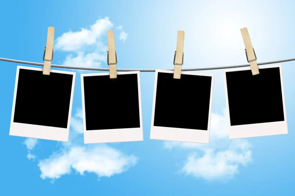 stock image Blank photographs hanging on a clothesline with blue sky