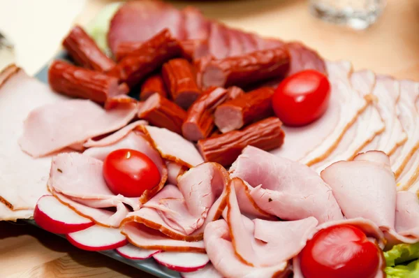 stock image Platter of cold cuts and sausages with ham and tomatoes