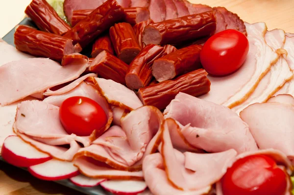 stock image Platter of cold cuts and sausages with ham and tomatoes