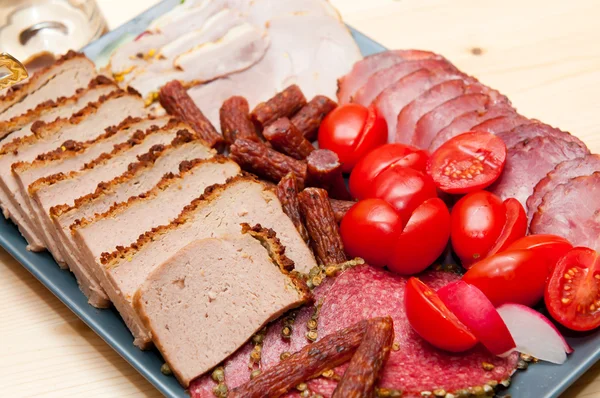 Stock image Platter of cold cuts and sausages with ham and tomatoes