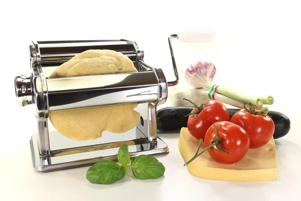 Masa de fideos con una máquina de pasta y tomates —  Fotos de Stock
