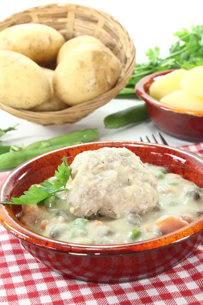 Cooked meatballs in a white sauce with capers and potatoes — Stock Photo, Image