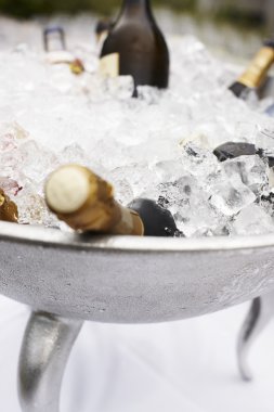 Bottles of champagne cooling on ice clipart