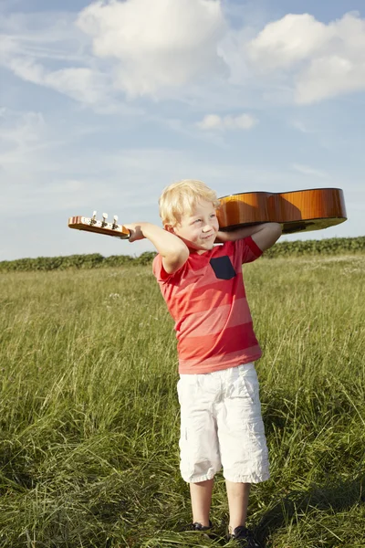 Small boy with wooden guitar — 스톡 사진