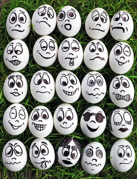 Fehér tojás és sok vicces arcok — Stock Fotó
