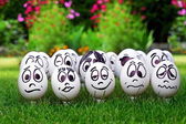 White eggs and many funny faces, garden party