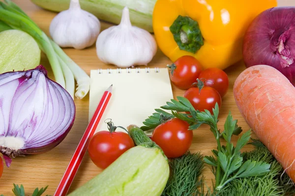Fresh vegetables and a notebook — Stock Photo, Image
