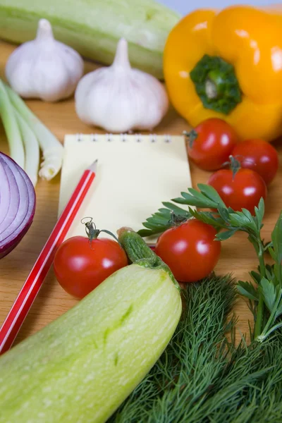 Fresh vegetables and a notebook — Stock Photo, Image
