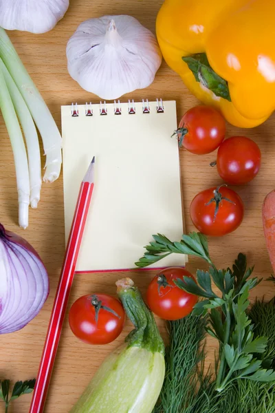 Stock image Fresh vegetables and a notebook