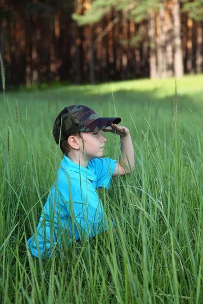 Boy sitting in tall grass — Stock Photo, Image