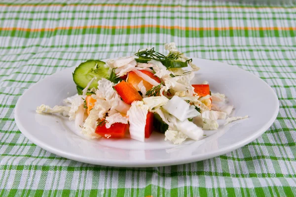 stock image White plate with fresh vegetable salad