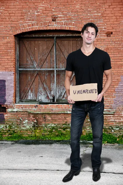 Hombre sosteniendo una señal de desempleo — Foto de Stock