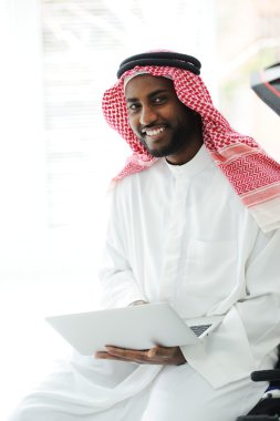 Black Arabic man working on laptop clipart