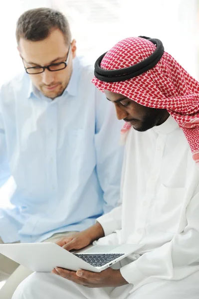 Arabic black and caucasian men working together on laptop — Stock Photo, Image