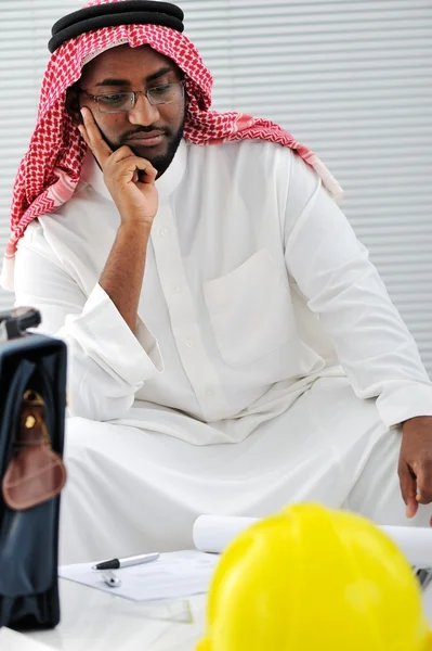Arabic engineer having a concern about the plans — Stock Photo, Image