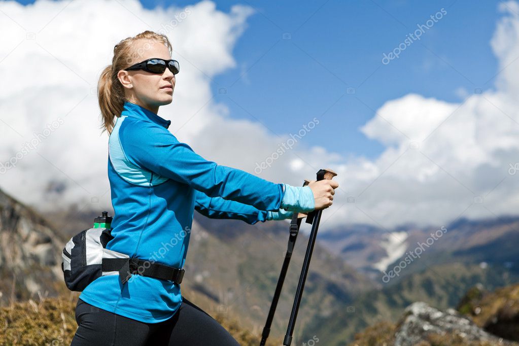 Woman nordic walking and exercising in mountains