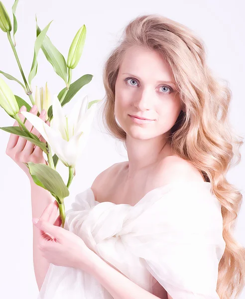 Beautiful young woman with white lily — Stock Photo, Image