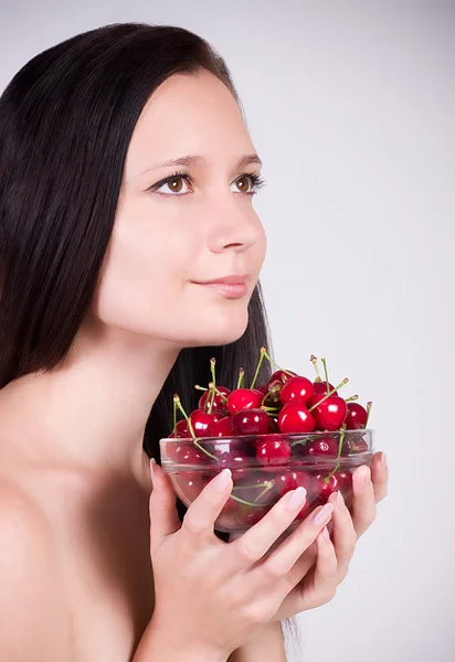 Woman with cherries on background — Stock Photo, Image