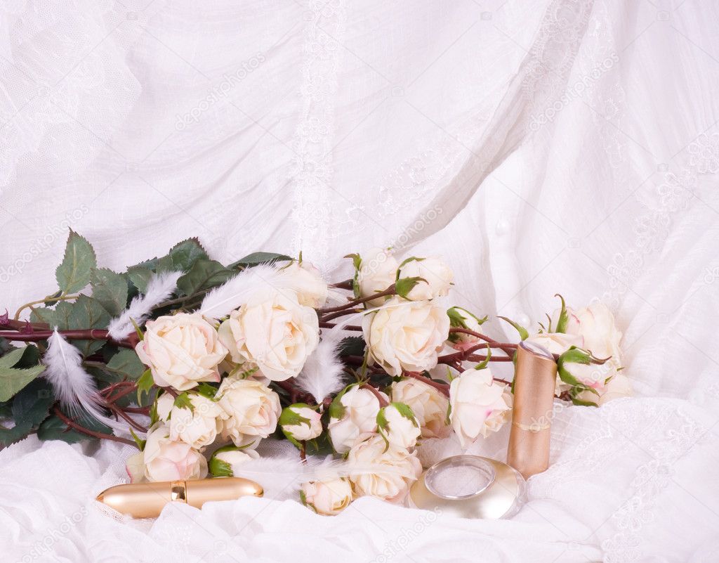 Beautiful bridal flowers with perfume bottles and eyeshadow