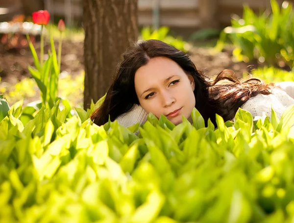 Beautiful woman in spring green lilies of the valley — Stock Photo, Image