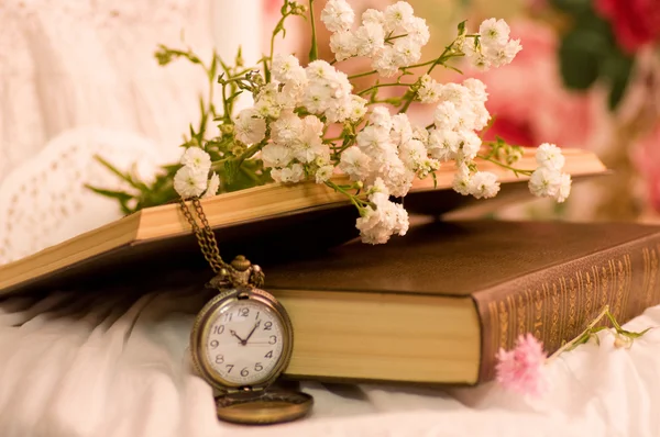 Lindas flores, livros e relógio antigo — Fotografia de Stock