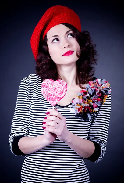 Frenchwoman with pink spiral lollipops — Stock Photo, Image