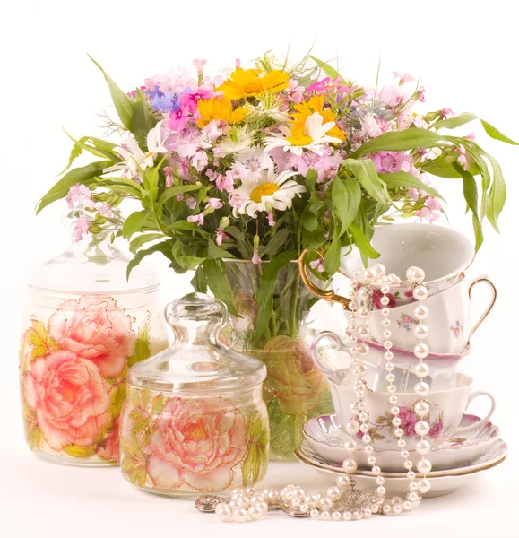 Vintage elegant cups with beads and flowers — Stock Photo, Image