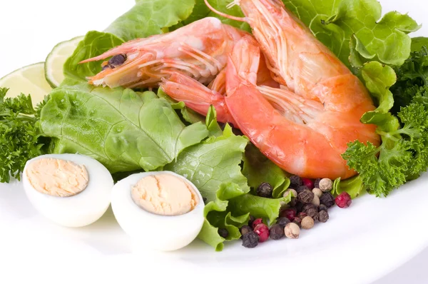 Вкусная жареная креветка с салатом и яйцами — стоковое фото