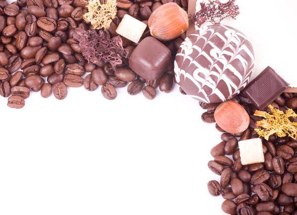 Coffee beans and sweetnesses on white background