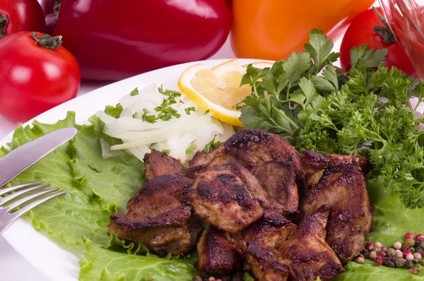 Appetizing weal kebab on skewers with tomatoes, pepper and greens — Stock Photo, Image
