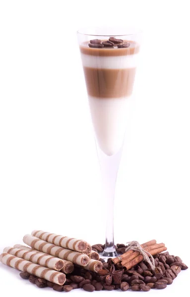 Смачний десерт з кавовими зернами та корицею на білому тлі — стокове фото