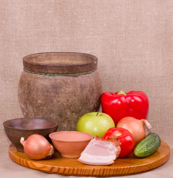 Clay pots, apple, vegetables and meat pork — Stock Photo, Image