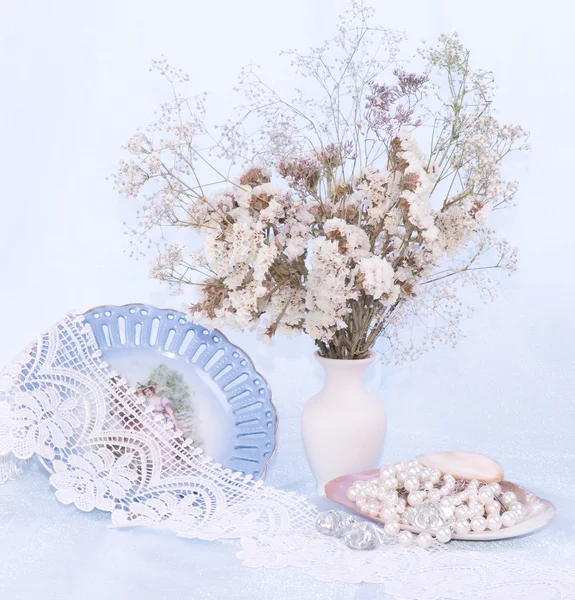 Beautiful flowers, vintage plate and beads — Stock Photo, Image