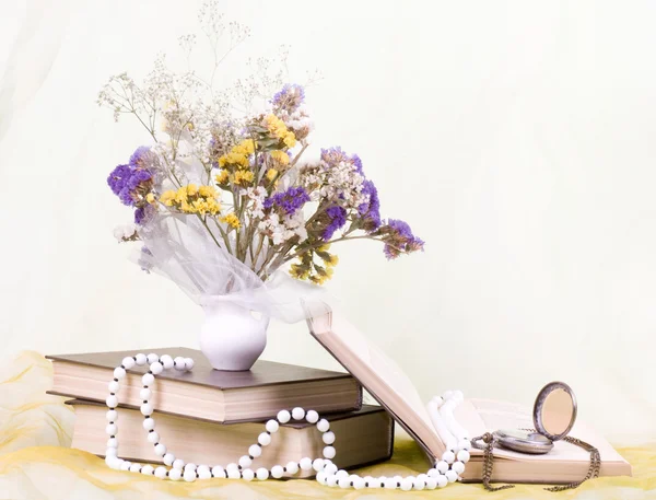 Beautiful spring flowers in a vase with banner add and book — Stock Photo, Image