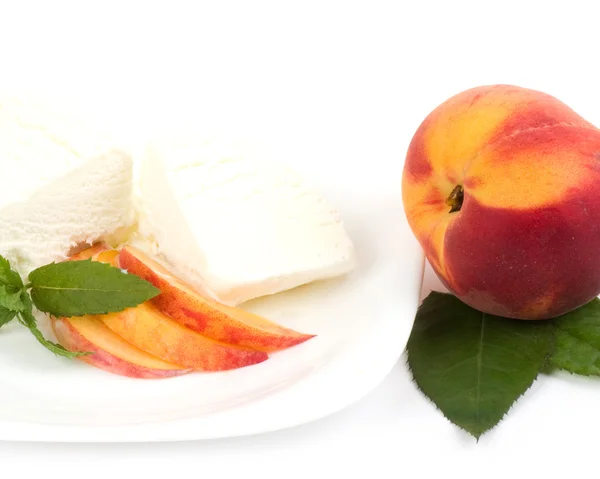 Tasty ice cream dessert with peach on white background — Stock Photo, Image