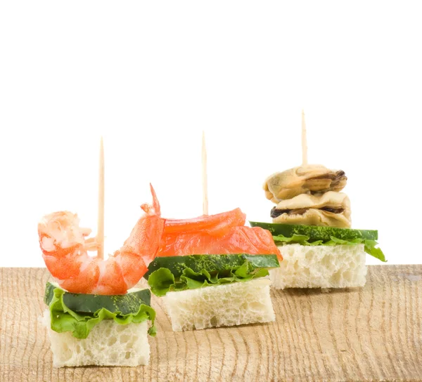 Set of tasty canape from seafood on a white background — Stock Photo, Image