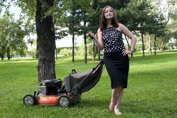 Girl with a lawn mower — Stock Photo, Image