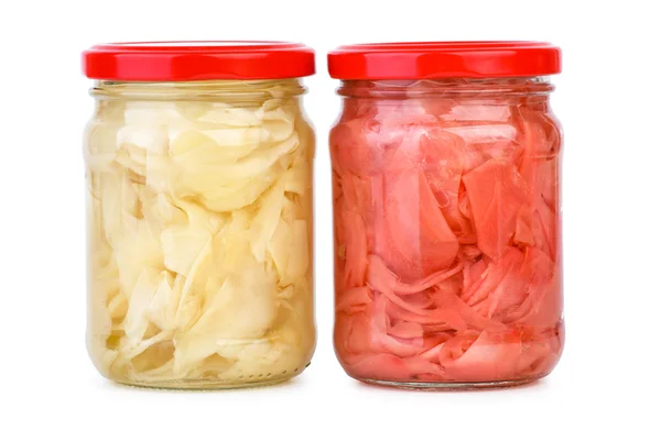 Glass jars with white and pink marinated sliced ginger roots — Stock Photo, Image