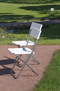 White chair in the garden clipart